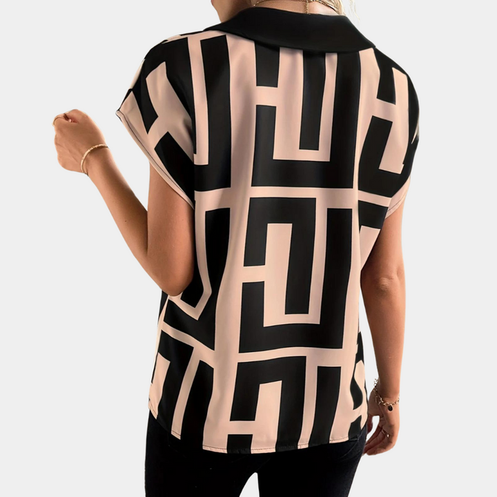 https://cdn.shopify.com/s/files/1/0830/7487/5738/files/Aria___Geometric_Graphic_Print_V-Neck_Blouse_1.png?v=1778598156