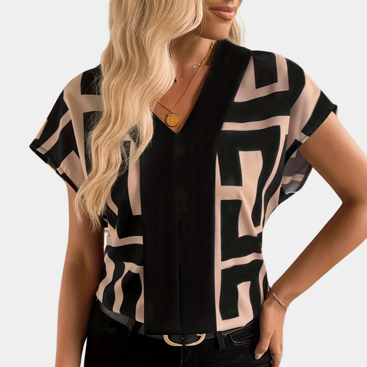 https://cdn.shopify.com/s/files/1/0830/7487/5738/files/Aria___Geometric_Graphic_Print_V-Neck_Blouse_2.png?v=1778598156