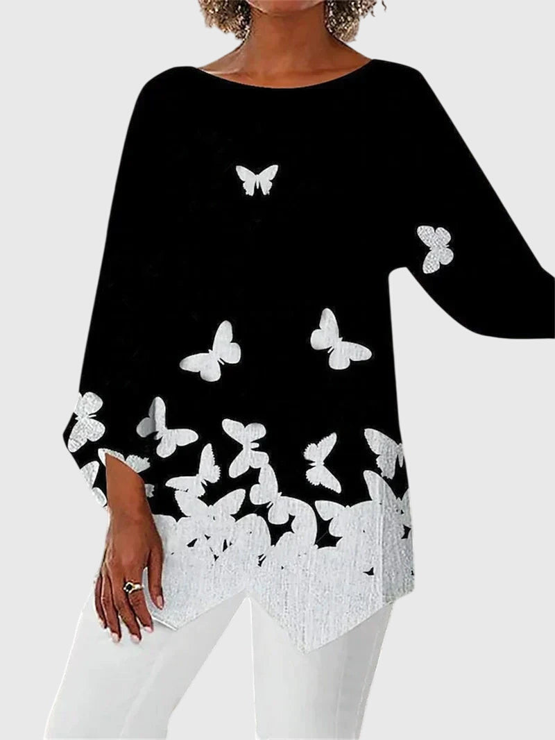 https://cdn.shopify.com/s/files/1/0830/7487/5738/files/Eleanor___Elegant_butterfly_print_top_with_asymmetric_hem_4.jpg?v=1778598148
